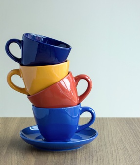 stack-of-colorful-coffee-cups-on-table_1373-61.jpg
